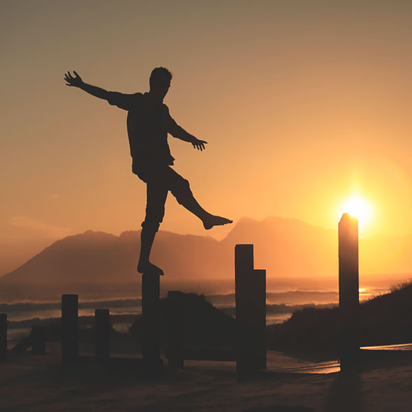 Man walking up wooden posts